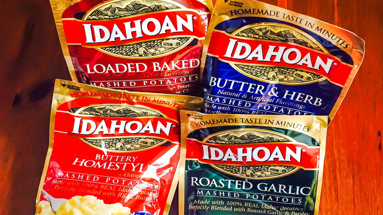 Several varieties of instant potatoes in envelopes are displayed.