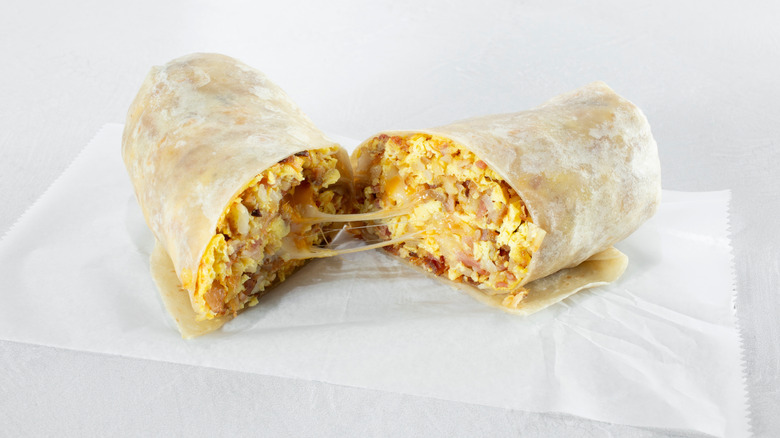 Cheesy breakfast burrito cut in half