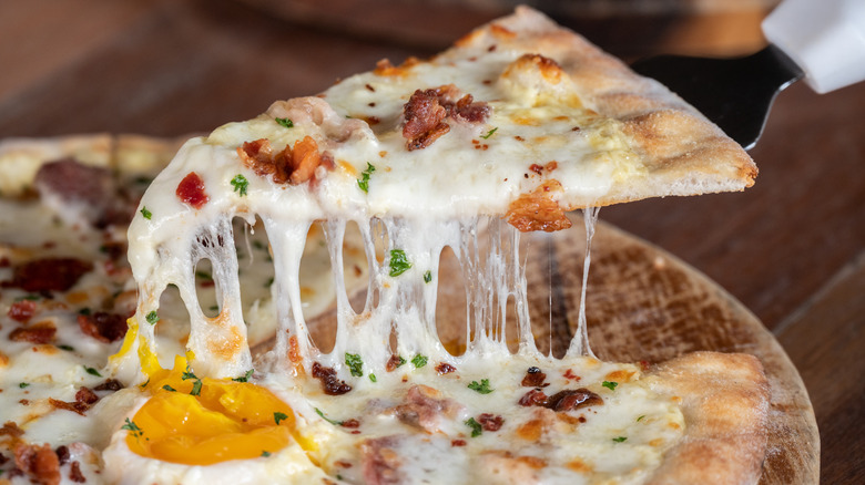 Sliced ​​breakfast pizza with egg