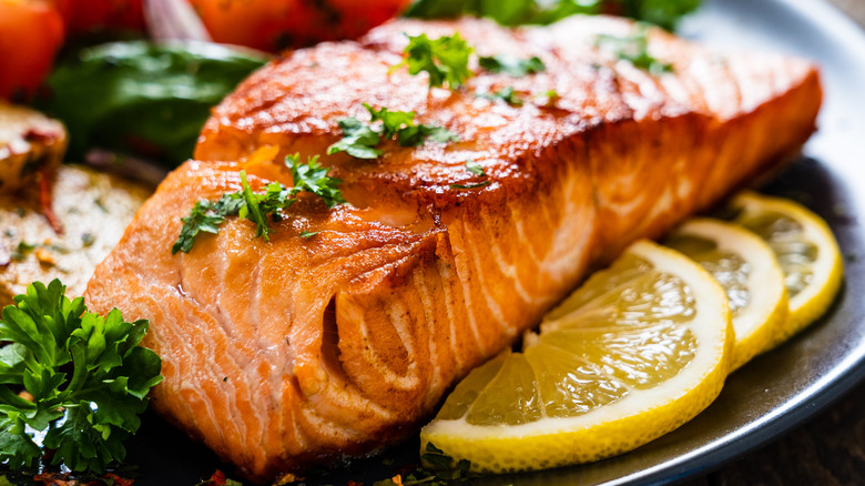 Cooked salmon fillet garnished with herbs