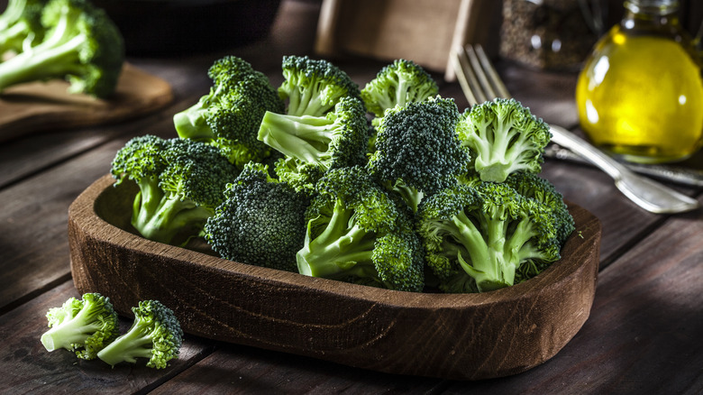 raw broccoli in a wooden bowl