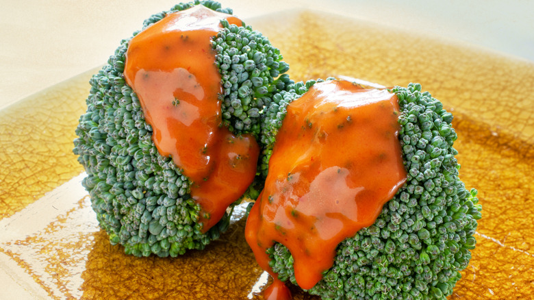 broccoli florets with catalina dressing on them
