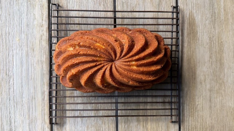 Brown butter bourbon loaf cake cooling on rack