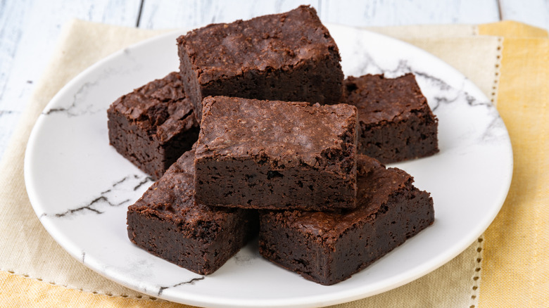 White plate of brownie squares.