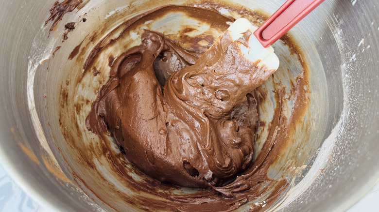 Brownie batter dip in mixer bowl with rubber spatula