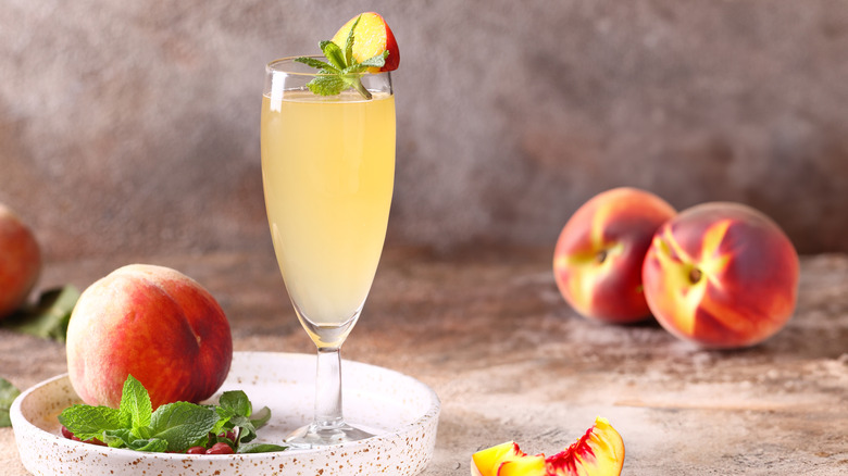 a bellini with fresh peaches