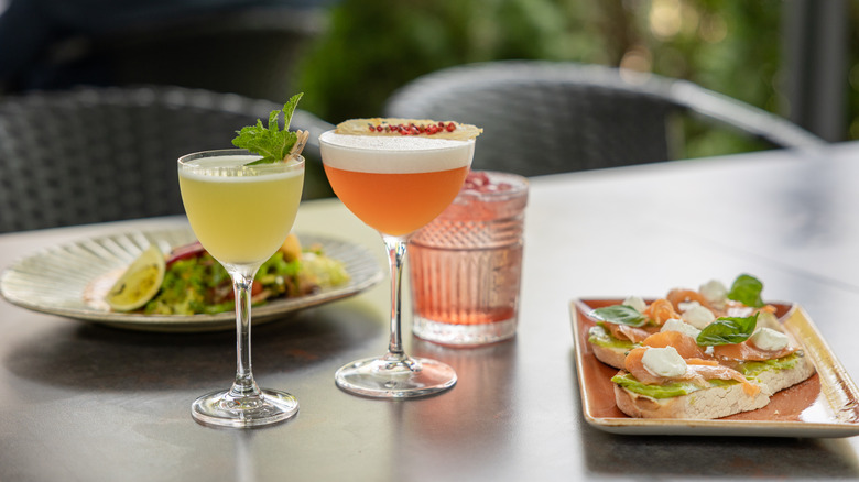 Two cocktails with brunch food