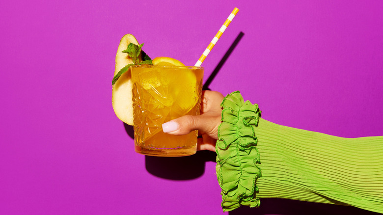 woman holding a screwdriver cocktail