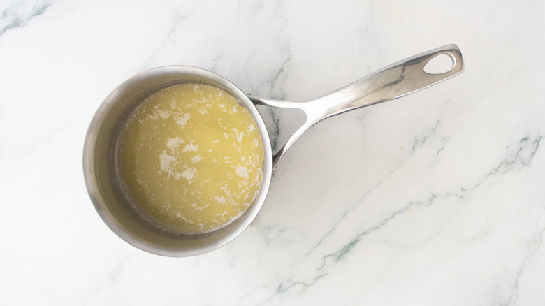 A medium saucepan with melted butter.