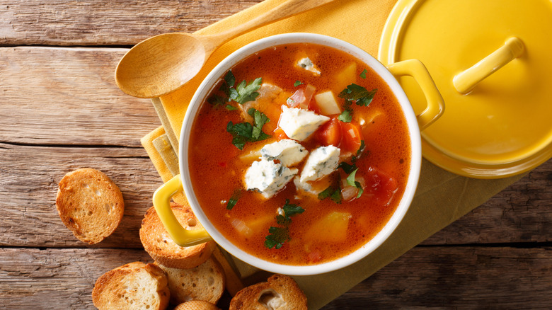 Buffalo chicken soup topped with blue cheese and a side of bread
