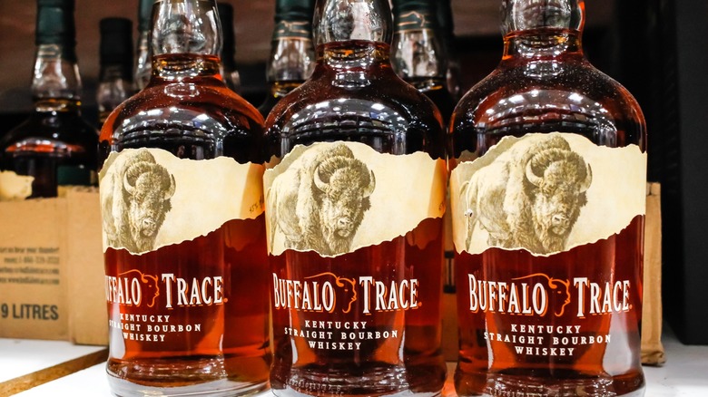 several bottles of buffalo trace bourbon displayed on grocery store shelves
