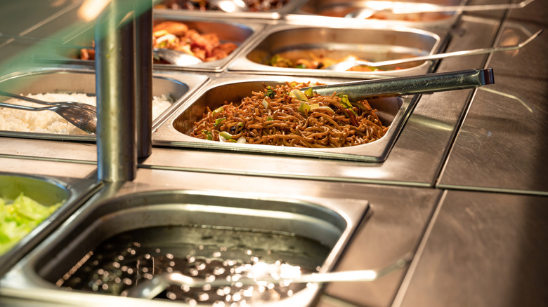 Food under a heating lamp at an Asian buffet