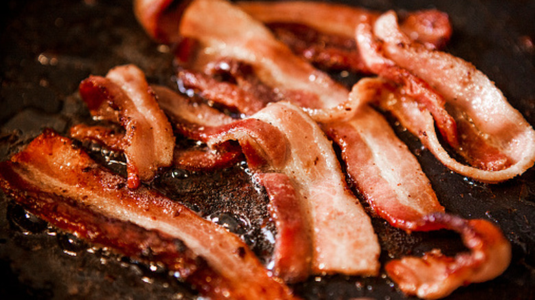 Sizzling bacon frying in a pan