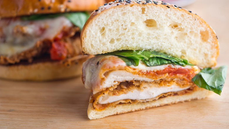 Classic traditional chicken Parmesan, breaded chicken breast battered and fried and served on sesame seed bun with melted mozzarella cheese and tomato sauce and crisp fresh.