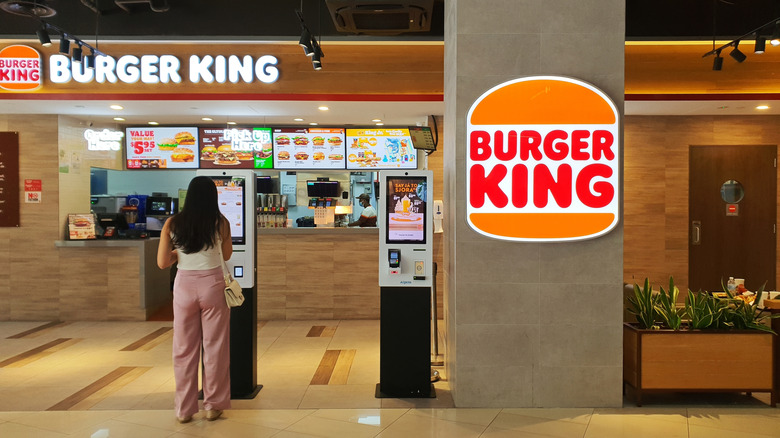 woman ordering food at the self serve kiosk at Burger King