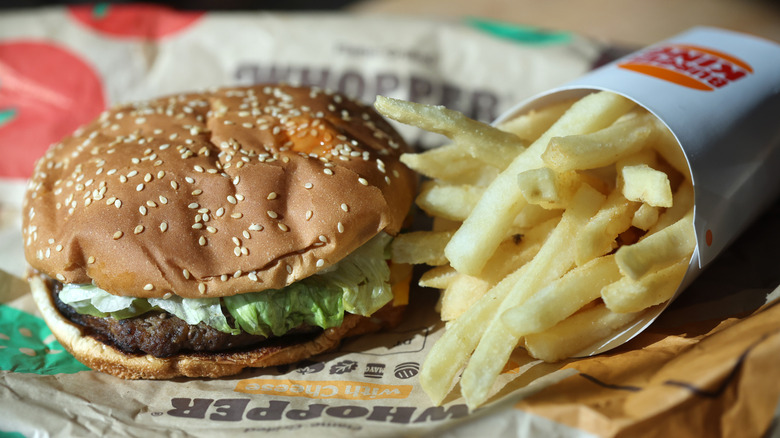 A Burger King whopper and fries on a tray.