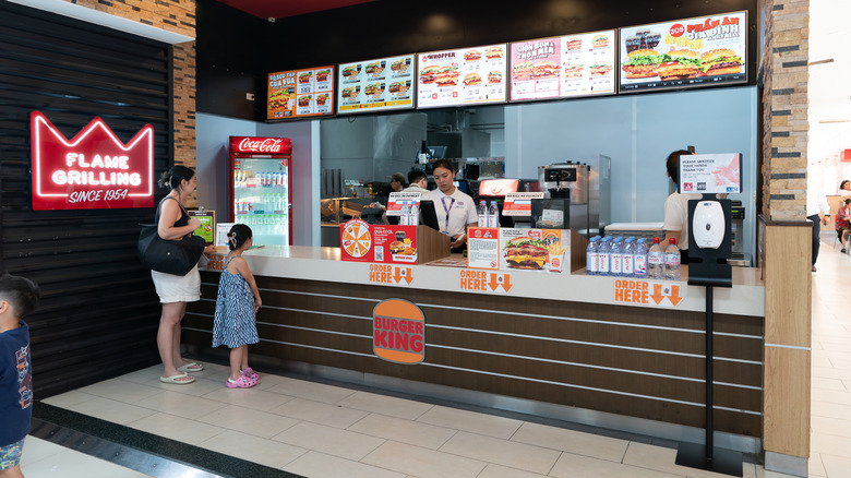Woman and girl at a Burger King counter with an employee