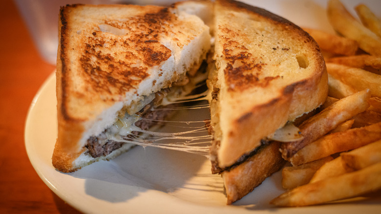patty melt with fries on a plate
