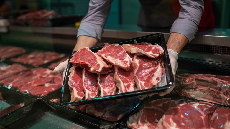 Butcher holding meat