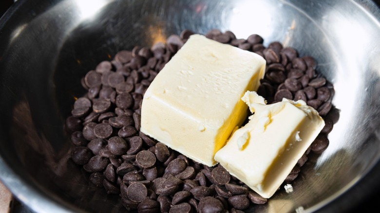 White butter in bowl with dark chocolate chips.