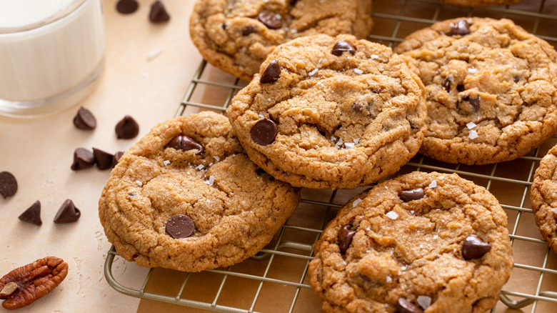Chocolate chip cookies on a metal cooling rack.