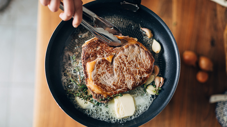 Steak in pan with butter