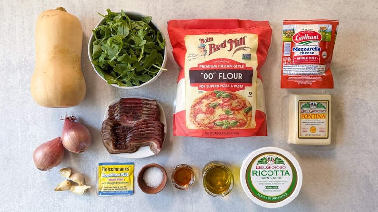 Butternut squash and maple bacon pizza ingredients on countertop