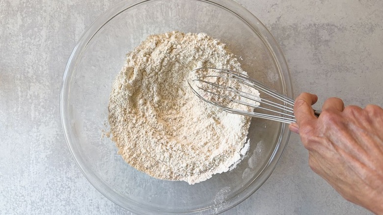 Whisking together dry ingredients for pizza dough