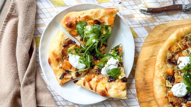 Slices of butternut squash and maple bacon pizza on plate