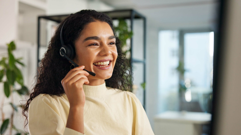 Woman smiling while wearing headset