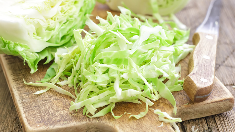 Chopped cabbage on a wooden board.