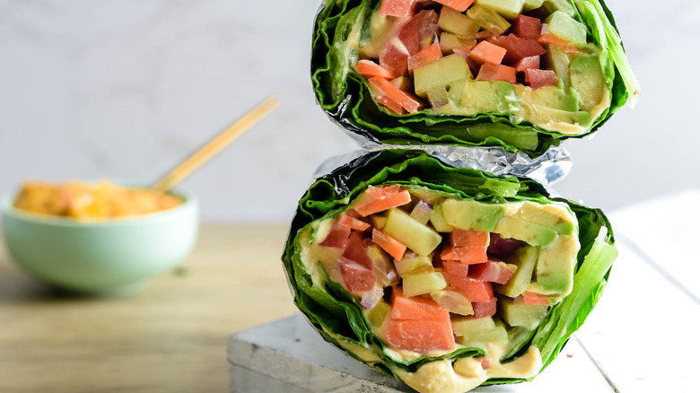 lettuce wrap held in foil on a wooden table