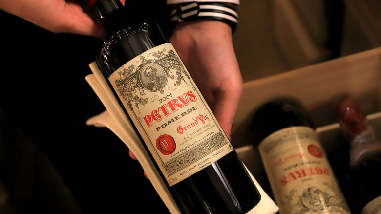A bottle of Petrus, made with 100% Merlot grapes.