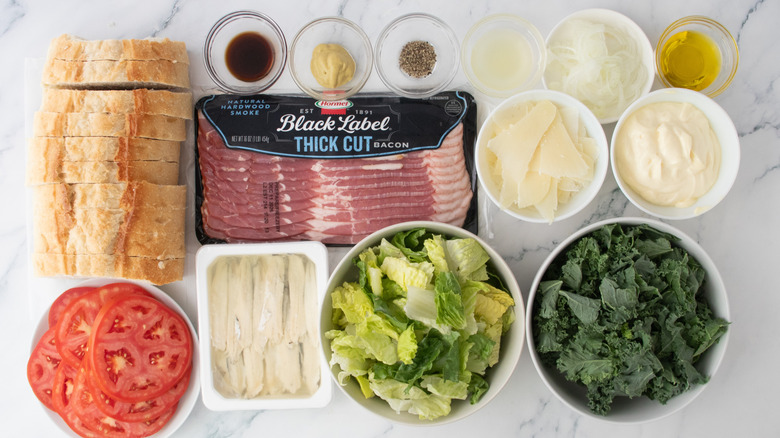 An overhead shot of caesar salad and BLT ingredients