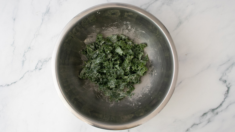 A large bowl filled with caesar salad-dressed kale