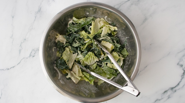 A large bowl filled with tossed caesar salad