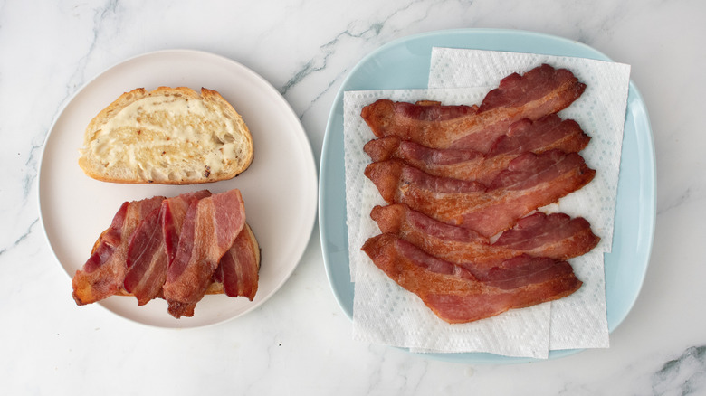 Slices of bacon added to a slice of caesar-dressed toasted bread