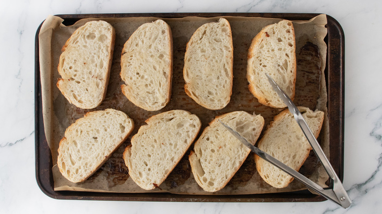 A large baking sheet topped with bread slices