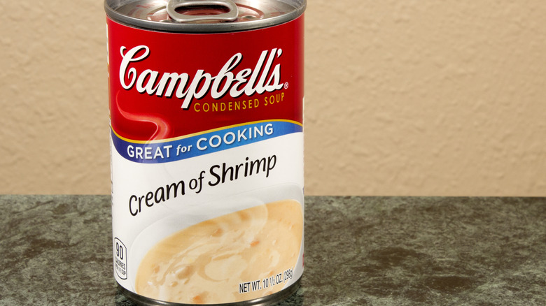 A can of Campbell's Cream of Shrimp Soup sit on top a granite counter.
