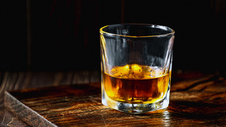 Bourbon glass on wooden board