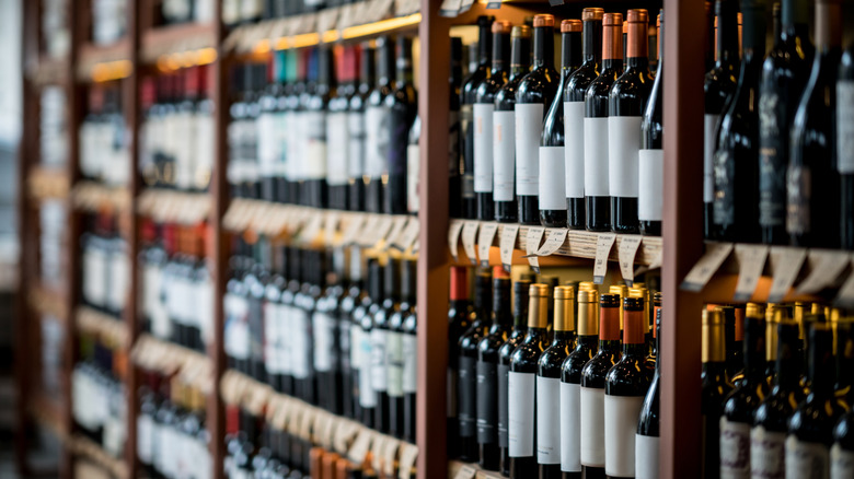 Dozens of wine bottles on a shelf