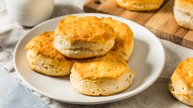 Four buttermilk biscuits on a white plate