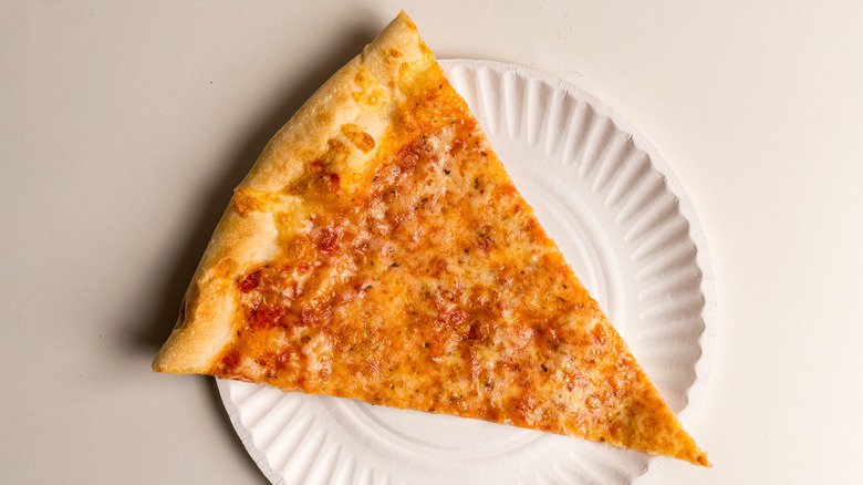Slice of cheese pizza on a paper plate