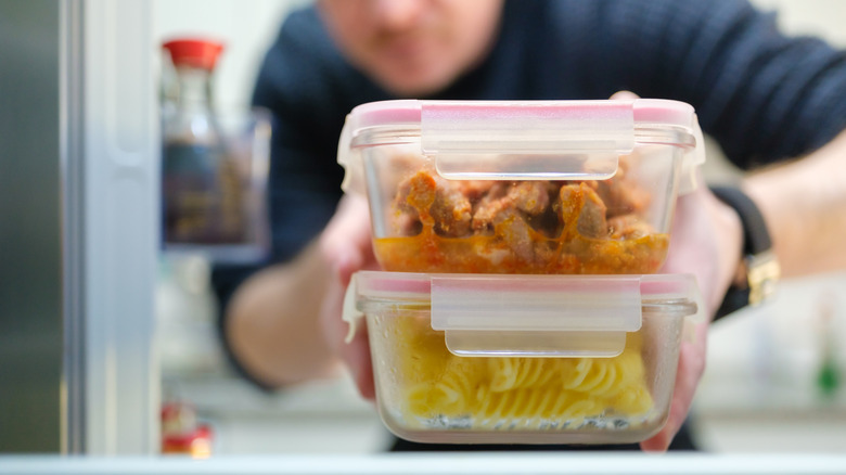 Person taking leftovers from fridge