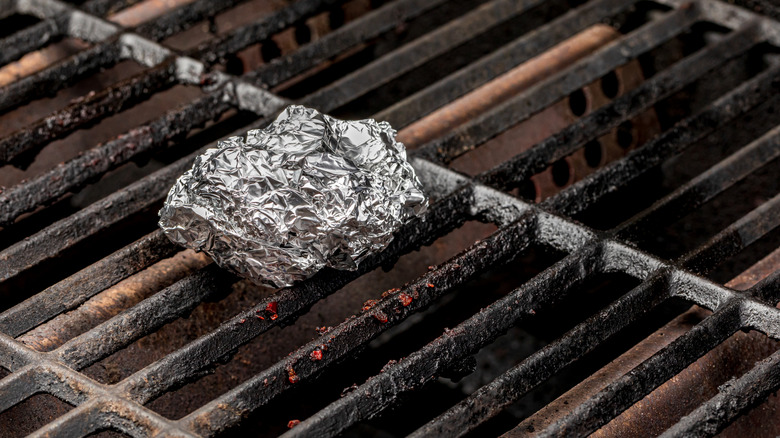 Food wrapped in aluminum foil on grill