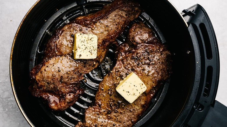 Butter-topped steaks in air fryer