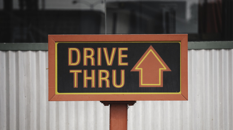 A sign with the words 'drive thru' and an arrow pointing up