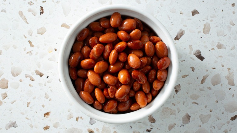Top-down look at a ceramic carafe of beans fresh out of a can.