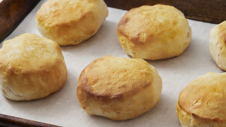Store bought biscuits have been baked on parchment paper.