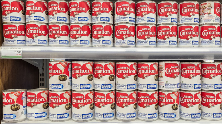 Cans of condensed milk on a grocery store's shelves